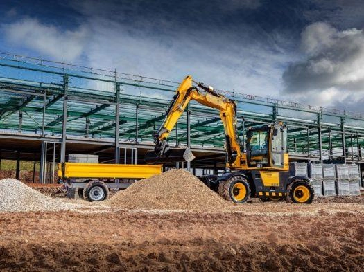 A Comprehensive Guide to Representative Models of JCB Excavators 3 JCB Hydradig 110W wheeled excavator working on an urban road maintenance project, featuring its compact design and rubber tires